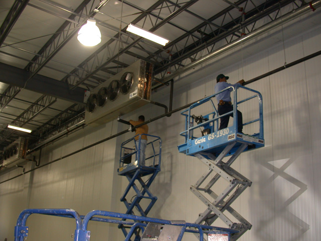 Electrical crew working on elevated access equipment